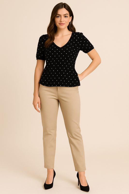 Model wearing black v-neck top with white polka dots